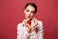 Smiling woman holding red heart symbol of Valentines day Royalty Free Stock Photo