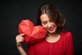 Smiling woman holding red polygonal heart shape Royalty Free Stock Photo