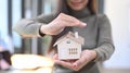 Woman holding small house model. Real estate and property insurance concepts. Royalty Free Stock Photo