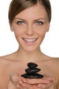 Smiling woman holding stones in hand Royalty Free Stock Photo