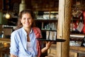 Smiling woman holding tray of drinks at a bar