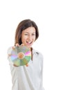 Smiling woman holding up compact disc or cd and looking at came Royalty Free Stock Photo