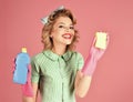 Smiling woman housewife dressed in retro style. Happy Housekeeper. Retro woman cleaner on pink background. Pinup woman Royalty Free Stock Photo