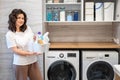 Smiling woman housewife posing at white bathroom laundry cupboard storage minimalism organizing Royalty Free Stock Photo