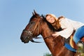 Smiling woman hugging beautiful bay horse Royalty Free Stock Photo