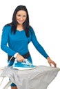 Smiling woman ironing a shirt