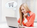 Smiling woman with laptop computer and credit card Royalty Free Stock Photo