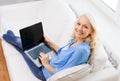Smiling woman with laptop computer at home Royalty Free Stock Photo