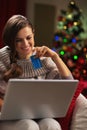 Smiling woman with laptop and credit card near christmas tree Royalty Free Stock Photo