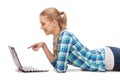 Smiling woman with laptop and pointing finger Royalty Free Stock Photo