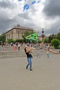 Smiling woman launches a kite into the sky at the kite festival in Volgograd