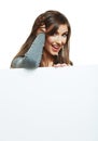 Smiling woman leaning on big blank board . Royalty Free Stock Photo