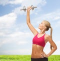 Smiling woman lifting steel dumbbell Royalty Free Stock Photo