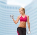 Smiling woman lifting steel dumbbell Royalty Free Stock Photo