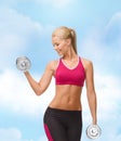 Smiling woman lifting steel dumbbell Royalty Free Stock Photo