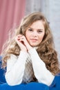 Smiling woman with long curly curls posing