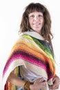 Smiling woman looking at camera, wearing a colored pashmina over a white background