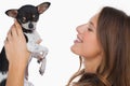 Smiling woman looking at her chihuahua Royalty Free Stock Photo