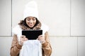 Smiling woman looking tablet computer screen on brown background Royalty Free Stock Photo