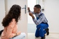 Technician Fixing The Door Lock With Screwdriver At Home Royalty Free Stock Photo