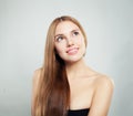 Smiling woman looking up . Cute girl with natural healthy hair and clear skin Royalty Free Stock Photo