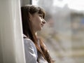 Young smiling woman looks out the window