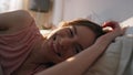 Smiling woman lying bed in morning. Serene calm female looking camera resting Royalty Free Stock Photo