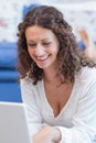 Smiling woman lying on the floor and using her laptop Royalty Free Stock Photo