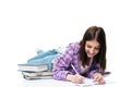 Smiling woman lying on the floor and writing in notebook Royalty Free Stock Photo