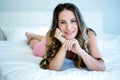 smiling woman lying on her bed Royalty Free Stock Photo