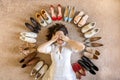 Smiling woman lying with shoes around shopping consumerism vogue and fashion top view Royalty Free Stock Photo