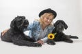 Smiling woman is lying with two Big Schnauzer Dogs