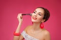 Smiling Woman with makeup brush. She is standing Royalty Free Stock Photo