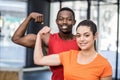 Smiling woman and man contracting biceps