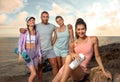 Fitness team. A happy group of runners rest after running along the sea coast. Sports concept for social media Royalty Free Stock Photo