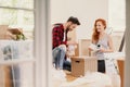 Smiling woman and man packing stuff while moving out from home Royalty Free Stock Photo