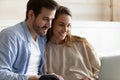 Smiling woman and man using laptop, looking at screen together Royalty Free Stock Photo