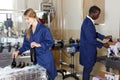 Smiling woman and man winemakers packing bottles with new wine in box