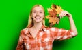 Smiling woman with maple leaves in hand. Happy blonde girl in plaid shirt. Autumn sales.