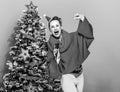 Smiling woman with microphone singing near Christmas tree Royalty Free Stock Photo