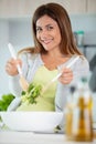 smiling woman mix sald in glass bowl