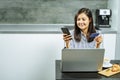 Smiling woman online shopping using a smartphone laptop and credit card at home Royalty Free Stock Photo