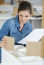 smiling woman opening cardboard box at home Royalty Free Stock Photo