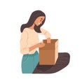 Smiling woman opening carton box parcel with purchase from online store Royalty Free Stock Photo