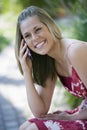 Smiling Woman Outdoors with Cell Phone Royalty Free Stock Photo