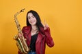 Smiling woman over isolated orange wall studio portrait. Showing victory sign Royalty Free Stock Photo