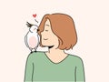 Smiling woman with parrot sitting on shoulder