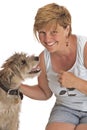 Smiling woman pets cute shaggy dog