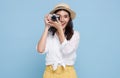 Smiling Woman photographer is taking images photo with dslr camera isolated studio blue background Royalty Free Stock Photo