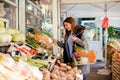 Smiling woman buying various vegetables Royalty Free Stock Photo